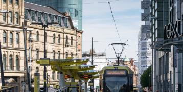 Electric tram in a city centre Electric tram in a city centre