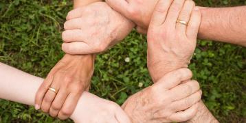 Six people holding each other's wrist