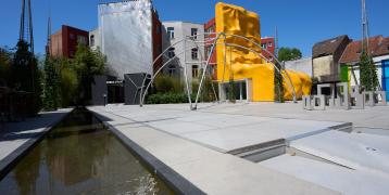 Square with modern buildings and pond