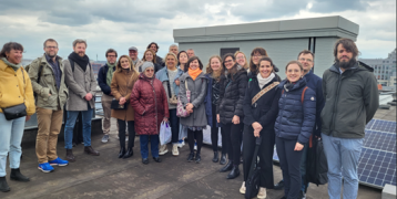 People gatherend on a roof during a study visit