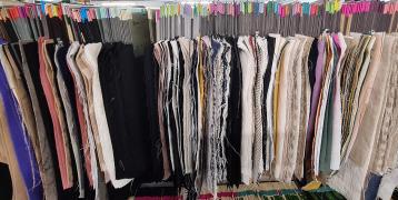 Many textile fabric samples hanging on a clothes haner