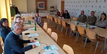 A group of persons in a meeting room