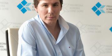 A man sitting on a table looking at the camera