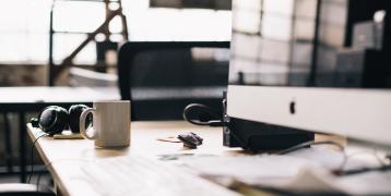 Desk with a computer and a mug Desk with a computer and a mug