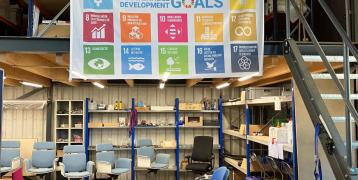 Workplace with a Sustainable Development Goals banner