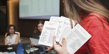 Woman holding up cards