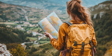Woman with map looking out over landscape