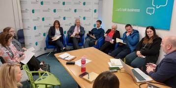 A group of people sits around a table