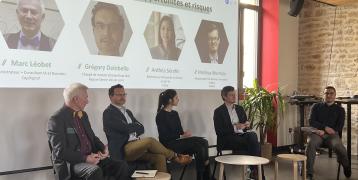 Panel discussion on "AI and the Public Sector: Opportunities and Risks" featuring Marc Léobet, Grégory Delobelle, Anthéa Serafin, Mathias Murmylo, and a moderator.