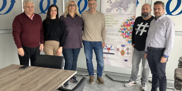 There is a group of people standing in a room.