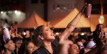 People having fun at a concert using reusable cups