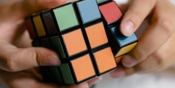 A person playing with a rubiks cube